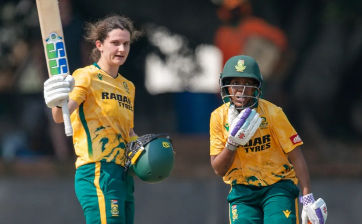 Laura Wolvaardt celebrates her fourth T20I hundred as Karabo Meso looks on.